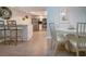 Open-concept dining and kitchen area with modern furnishings, sleek countertops, and stainless steel appliances at 1080 Peppertree W Ln # 602, Sarasota, FL 34242