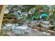 Outdoor grill area with picnic tables, dining tables, and lounge chairs at 1080 Peppertree W Ln # 602, Sarasota, FL 34242