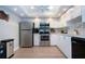Well-lit kitchen with white cabinets, stainless steel appliances, and sleek countertops at 1080 Peppertree W Ln # 602, Sarasota, FL 34242