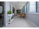 Inviting lanai showcases tile flooring, wicker seating, and bright windows, perfect for enjoying the serene surroundings at 1080 Peppertree W Ln # 602, Sarasota, FL 34242