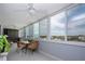 This beautiful lanai offers panoramic views through large windows, complemented by comfortable wicker seating and tile floors at 1080 Peppertree W Ln # 602, Sarasota, FL 34242