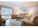 Inviting living room with cozy furnishings and a sliding glass door to the outside at 1080 Peppertree W Ln # 602, Sarasota, FL 34242