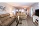 Comfortable living room with plush beige couches and a large opening to the dining area at 1080 Peppertree W Ln # 602, Sarasota, FL 34242