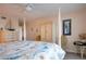 Bright main bedroom with a ceiling fan, luxury furnishings, and coastal decor at 1080 Peppertree W Ln # 602, Sarasota, FL 34242
