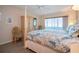 Main bedroom with decorative furniture, balcony access, and views of the ocean at 1080 Peppertree W Ln # 602, Sarasota, FL 34242
