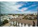 Scenic neighborhood view showcases buildings and tropical trees against a backdrop of a beautiful blue sky at 1080 Peppertree W Ln # 602, Sarasota, FL 34242