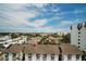 Neighborhood aerial view overlooking rooftops and palm trees against a blue, partially cloudy sky at 1080 Peppertree W Ln # 602, Sarasota, FL 34242