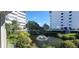 Balcony view of a pond and fountain, with high rise buildings in the background at 1080 Peppertree W Ln # 602, Sarasota, FL 34242