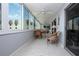 Enclosed porch with tile flooring, ceiling fans, and floor-to-ceiling windows at 1080 Peppertree W Ln # 602, Sarasota, FL 34242
