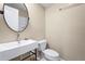 Modern bathroom featuring a stylish sink with a round mirror, toilet, and sleek fixtures at 111 Faubel St, Sarasota, FL 34242