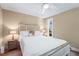 Cozy bedroom with wood floors, ceiling fan, natural light, and comfortable bed with floral accent pillow at 111 Faubel St, Sarasota, FL 34242