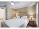 Cozy bedroom with wood floors, ceiling fan, natural light, and comfortable bed with floral accent pillow at 111 Faubel St, Sarasota, FL 34242