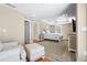 Spacious bedroom with tray ceilings, hardwood floors, large rug, and a comfortable sitting area at 111 Faubel St, Sarasota, FL 34242