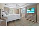 Beautiful bedroom with recessed lighting, ceiling fan, dresser, and tropical beach scene on TV at 111 Faubel St, Sarasota, FL 34242