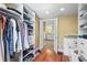 Well-organized walk-in closet with custom shelving, hanging space, and access to a bathroom at 111 Faubel St, Sarasota, FL 34242