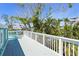 A bright deck with white railings offers lush greenery and a view at 111 Faubel St, Sarasota, FL 34242