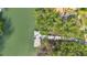 Aerial view of a private wooden dock extending into a tranquil waterway surrounded by lush green mangroves at 111 Faubel St, Sarasota, FL 34242