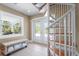 Entrance hall with a spiral staircase, bench seat and access to the outside at 111 Faubel St, Sarasota, FL 34242