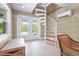 Bright foyer featuring a spiral staircase, tiled floor, and glass doors leading to the outdoors at 111 Faubel St, Sarasota, FL 34242