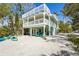 Two-story coastal home with balconies, beachside access, and space for kayaks and beach equipment at 111 Faubel St, Sarasota, FL 34242