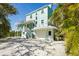 Charming home with a garage and additional staircase. The tropical landscape offers a private outdoor retreat at 111 Faubel St, Sarasota, FL 34242