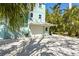 Garage parking space with extra parking. Lush tropical landscaping throughout the property at 111 Faubel St, Sarasota, FL 34242