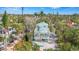 Charming two-story house featuring dual balconies and complemented by lush tropical surroundings and a sandy yard at 111 Faubel St, Sarasota, FL 34242