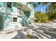Charming home with lush landscaping and white exterior stairs leading to a private side entry at 111 Faubel St, Sarasota, FL 34242
