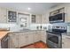 Updated kitchen featuring stainless steel appliances, granite countertops, and white cabinetry at 111 Faubel St, Sarasota, FL 34242