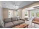 Well-lit living room with a couch, access to the outside, and staircase at 111 Faubel St, Sarasota, FL 34242
