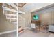 Cozy living room featuring a spiral staircase, TV, and comfortable seating arrangement at 111 Faubel St, Sarasota, FL 34242