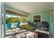 Covered patio with brick flooring, a grill, bicycles, and Adirondack chairs for relaxation at 111 Faubel St, Sarasota, FL 34242