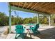 Relaxing patio area with teal Adirondack chairs and view of the garden and kayaks at 111 Faubel St, Sarasota, FL 34242