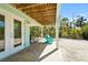 Covered outdoor space with a brick patio, double doors, and parking for bicycles at 111 Faubel St, Sarasota, FL 34242