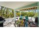 Outdoor covered patio with bikes, grill, and chairs overlooking the lush surroundings at 111 Faubel St, Sarasota, FL 34242