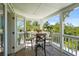 Covered outdoor dining area on a porch, with views of the property's lush landscape at 111 Faubel St, Sarasota, FL 34242