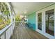 Covered porch with cozy seating and scenic green views at 111 Faubel St, Sarasota, FL 34242