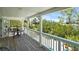 Covered porch featuring a table and chairs with beautiful green outdoor views at 111 Faubel St, Sarasota, FL 34242