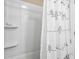 Enclosed shower with an abstract curtain and built-in shelving for toiletries at 111 Faubel St, Sarasota, FL 34242
