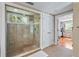 Large walk in shower with mosaic tiles, glass doors, a window, and multiple shower heads at 111 Faubel St, Sarasota, FL 34242