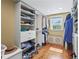 Organized walk-in closet with shelving, drawers, hanging rods, and hardwood floors at 111 Faubel St, Sarasota, FL 34242