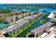 Aerial view of waterfront condos with boat docks and lush landscaping in a canal community at 1250 N Portofino Dr # 203, Sarasota, FL 34242