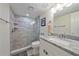 Updated bathroom featuring a glass enclosed shower and granite vanity at 1250 N Portofino Dr # 203, Sarasota, FL 34242