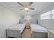 Comfortable bedroom with twin beds, neutral decor, and lots of natural light at 1250 N Portofino Dr # 203, Sarasota, FL 34242