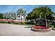 Siesta Harbor community sign surrounded by colorful landscaping and palm trees at 1250 N Portofino Dr # 203, Sarasota, FL 34242