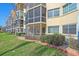 Exterior view of condo building, showing landscaping and lanais at 1250 N Portofino Dr # 203, Sarasota, FL 34242