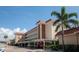 Exterior view showcasing the building with carport parking and well-maintained landscaping at 1250 N Portofino Dr # 203, Sarasota, FL 34242