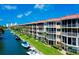 Beautiful waterfront condo building with boat docks, lush landscaping, and amazing views from multiple screened-in balconies at 1250 N Portofino Dr # 203, Sarasota, FL 34242