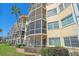 Exterior view of the condo building featuring multiple floors with lanais and well-maintained landscaping at 1250 N Portofino Dr # 203, Sarasota, FL 34242