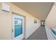 Exterior hallway entrance door featuring glass panel, the number 203, and a view of the complex through the glass at 1250 N Portofino Dr # 203, Sarasota, FL 34242